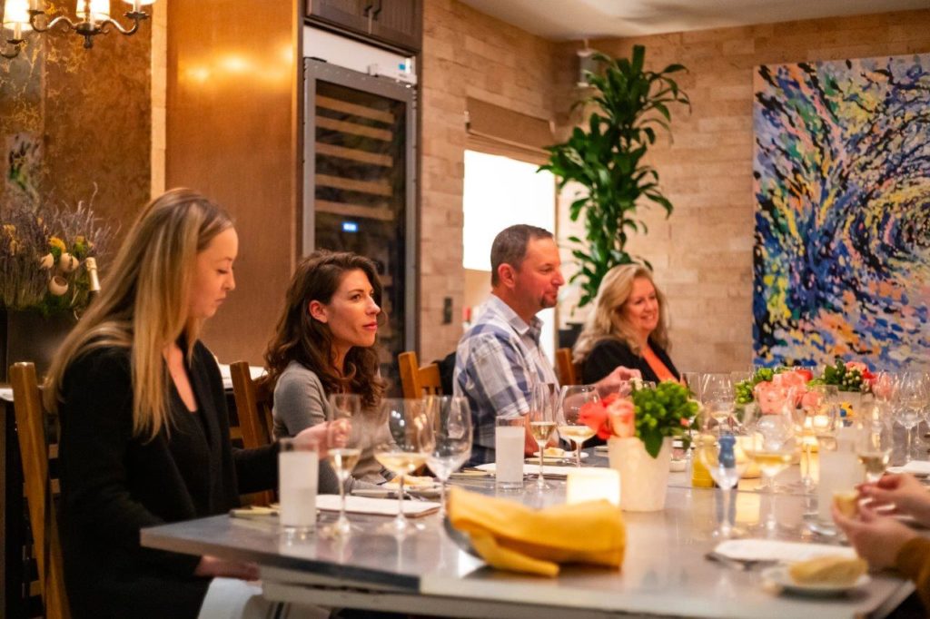 Four people dining in the Cork Room at bouchon