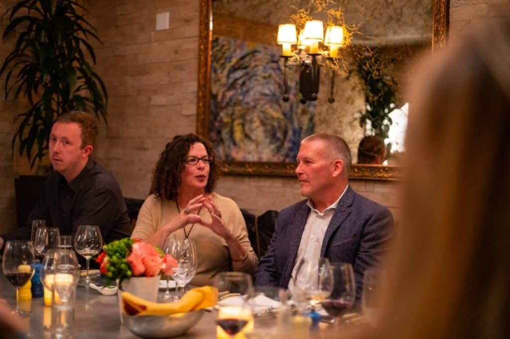 Three people dining in the Cork Room at bouchon