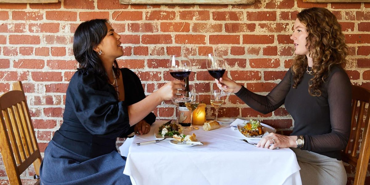 Two women drinking wine